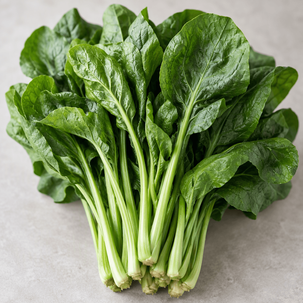 A fresh bunch of leafy greens with slender pale-green stems and broad, slightly crinkled leaves in shades of deep green.