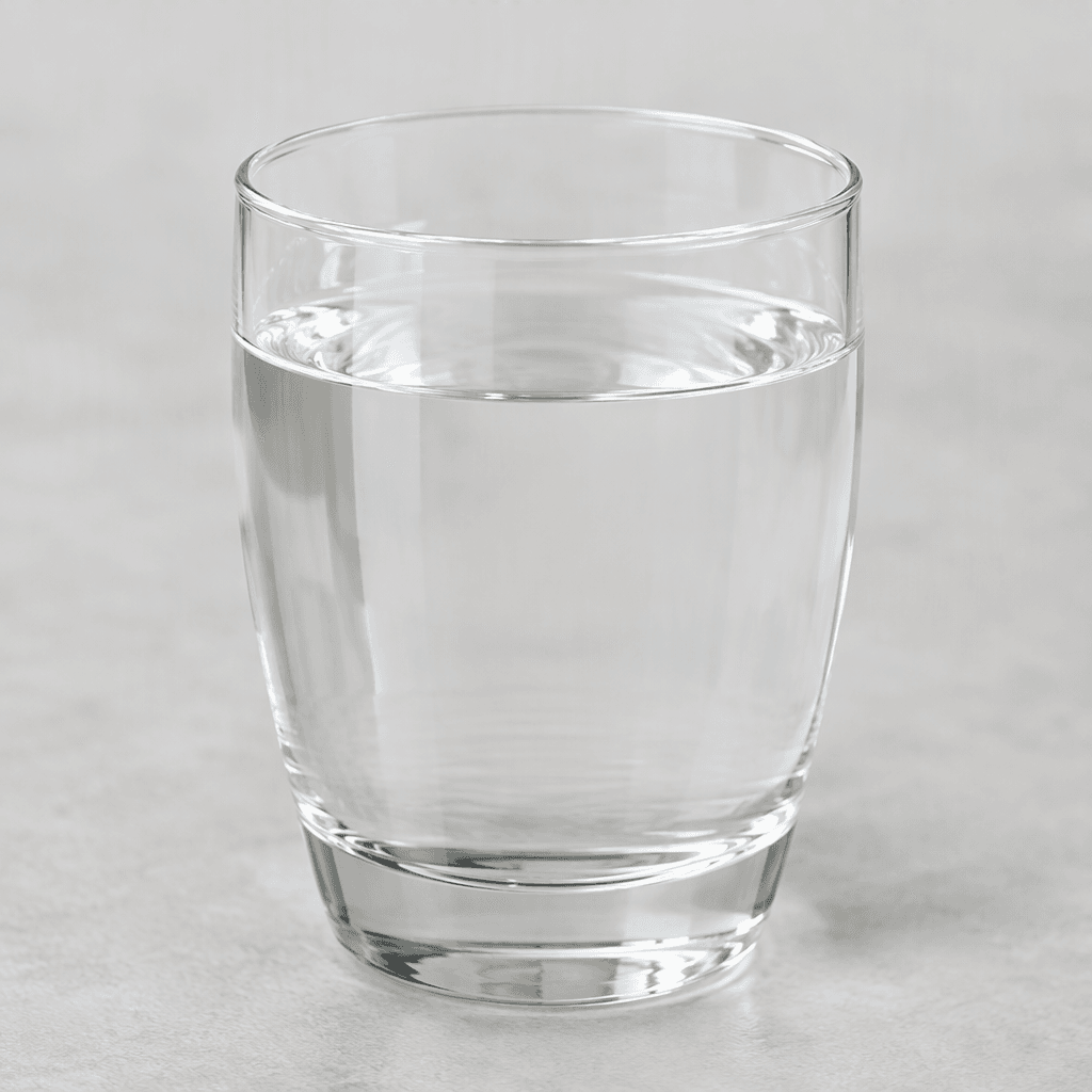A clear, colourless liquid with a watery texture, typically served in a transparent glass.
