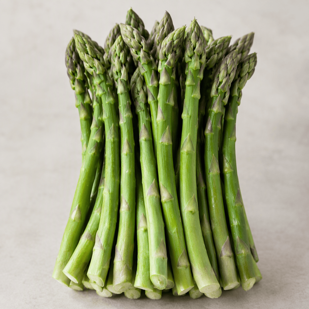 A bunch of slender green asparagus spears with smooth stalks, tightly layered pointed tips, and freshly cut pale ends.