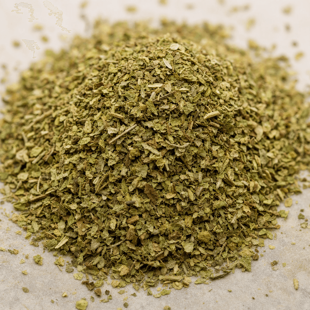 A small pile of dried oregano leaves, finely crumbled into irregular green and muted gray-green flakes with a few thin stems.