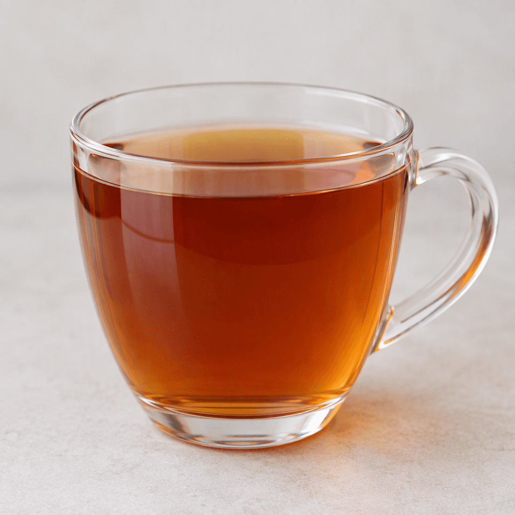 A clear glass or plain cup filled with transparent amber-brown tea, with no visible sugar, milk, herbs, fruit, or other additions, and a smooth surface with faint reflections.