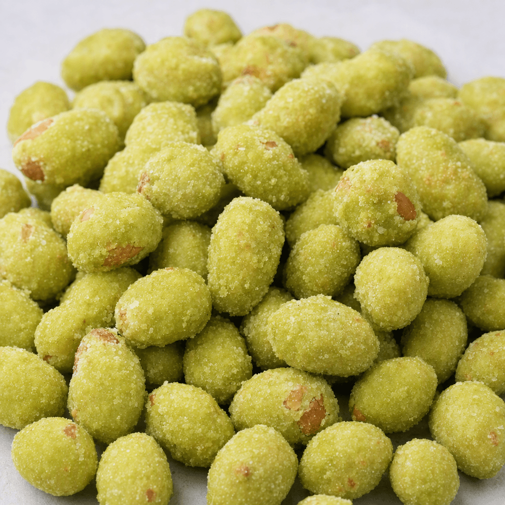Small oval peanuts are covered in a rough, uneven pale-green coating and lie in a loose pile.