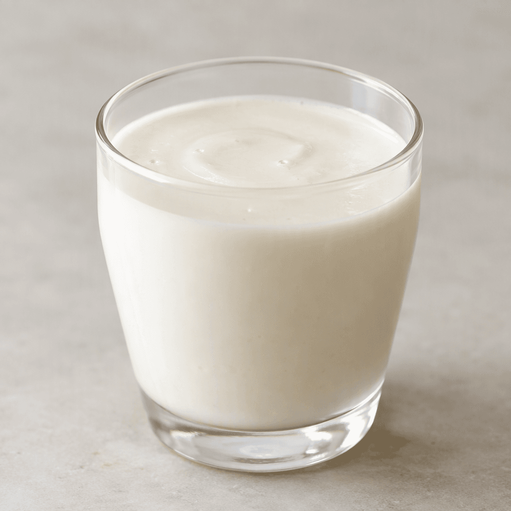 A smooth, opaque, creamy white drink with a slightly thick, pourable consistency.
