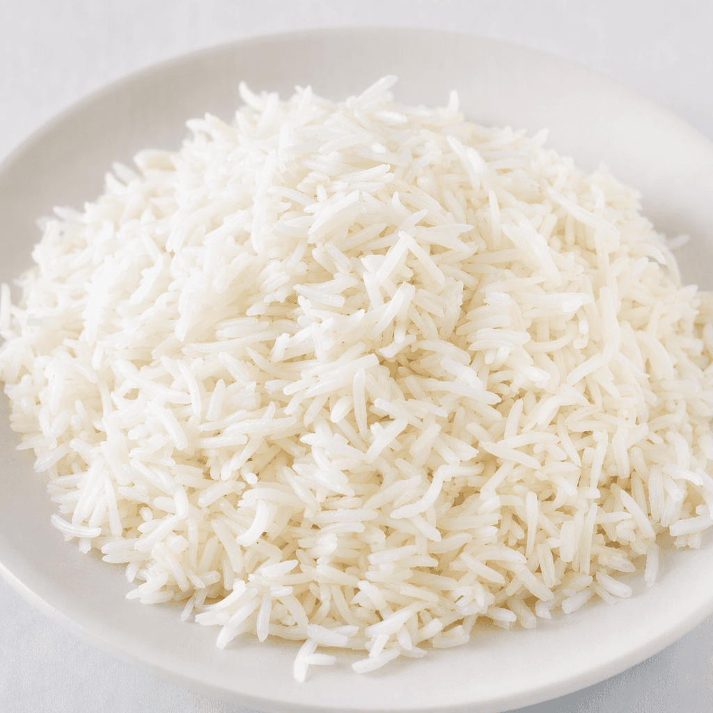 A fluffy mound of white, slender, separate rice grains with gently tapered ends, served on a plain plate.