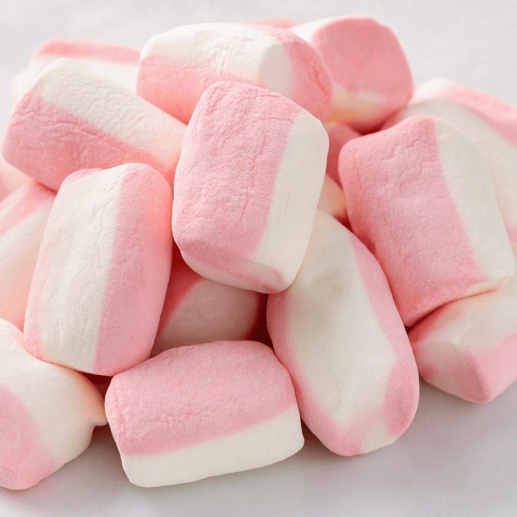 Soft, pillowy marshmallows in rounded cylindrical shapes, with smooth pastel pink and white sections, arranged in a small pile.