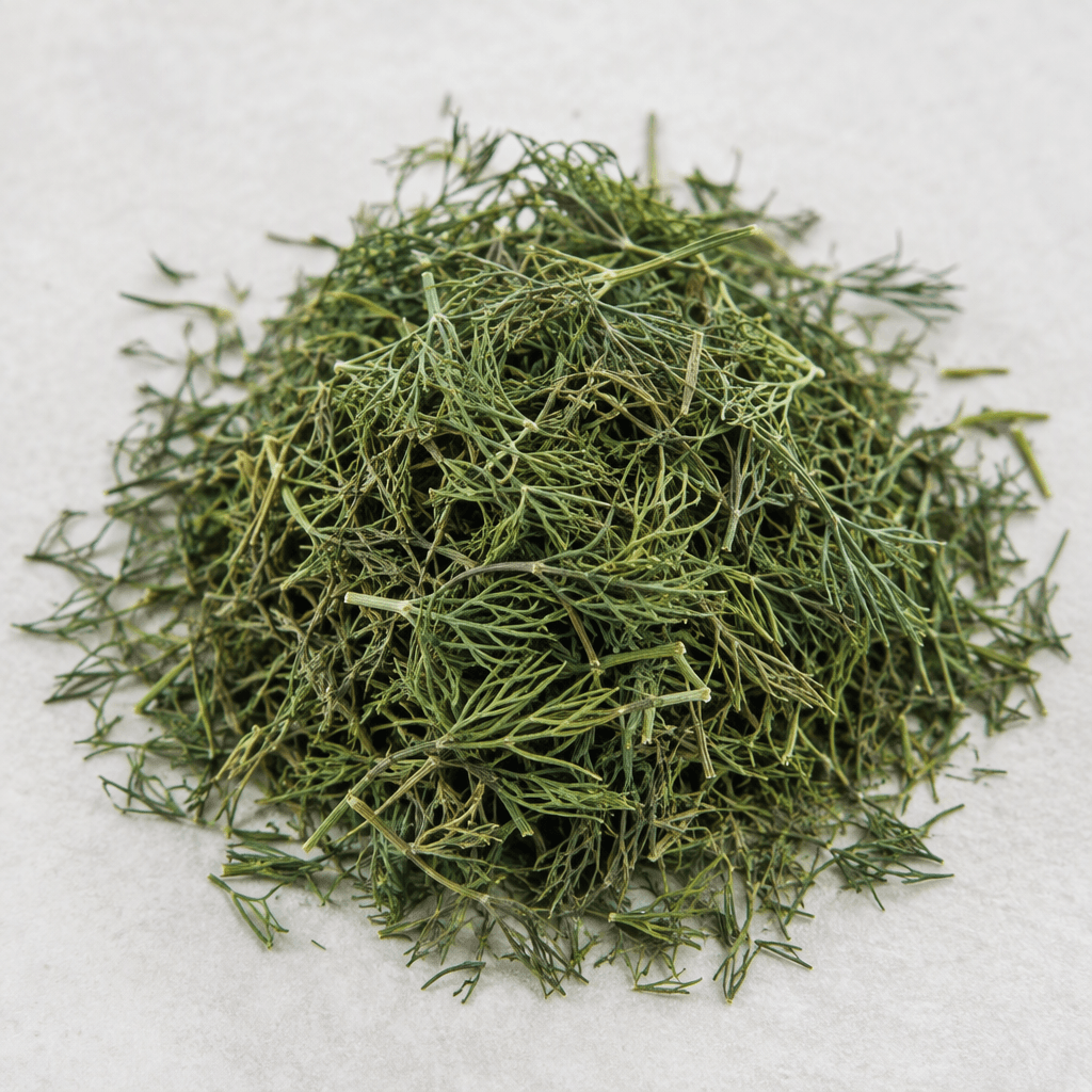 Loose, delicate dried dill consists of fine, feathery green leaves and thin threadlike stems, scattered in a small pile with a slightly uneven, brittle texture.