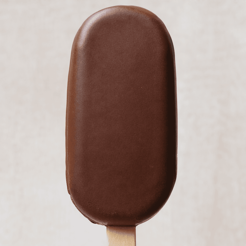 A rounded oblong ice-cream bar on a stick, covered in a smooth, dark-brown chocolate shell.