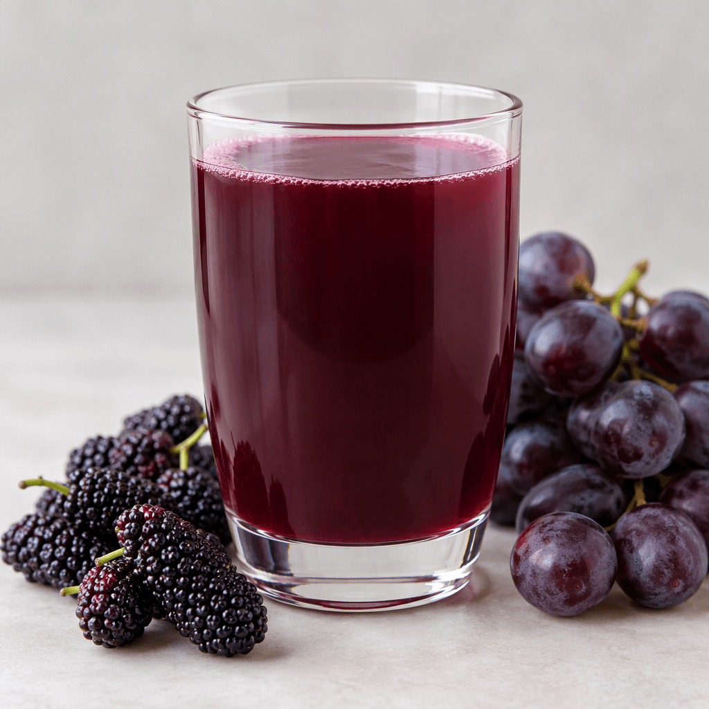 A deep purple-red black mulberry and grape juice with a smooth, lightly translucent appearance, served in a clear glass.