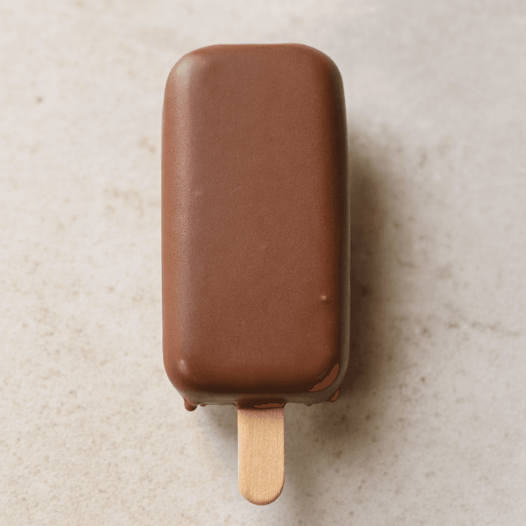 A smooth, rectangular ice cream bar coated in a thin chocolate shell, with a flat wooden stick extending from one end.