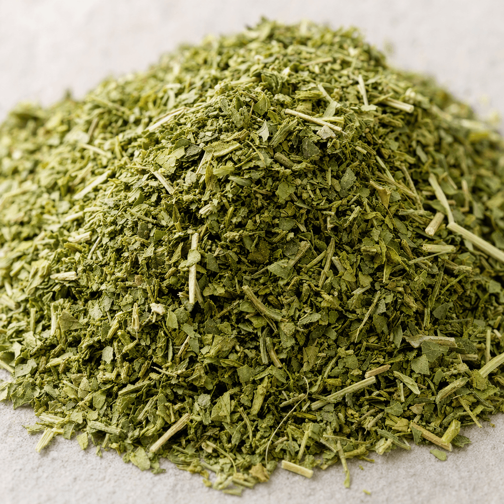 A loose blend of finely crumbled dried herbs, made up of small leafy flakes in shades of green with a few pale stems.
