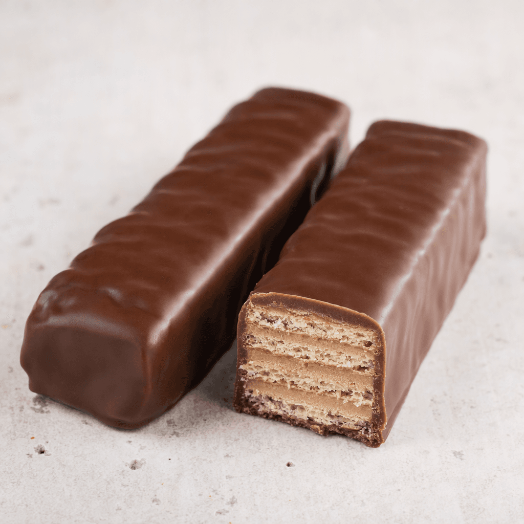 A long rectangular bar with a smooth, glossy brown chocolate coating, shown whole beside a cut piece revealing thin crisp wafer layers and pale brown cream between them.