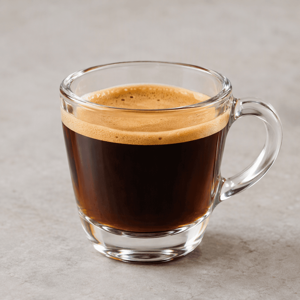 A small cup of extended espresso with a deep brown, translucent body and a thin layer of tan crema on the surface.