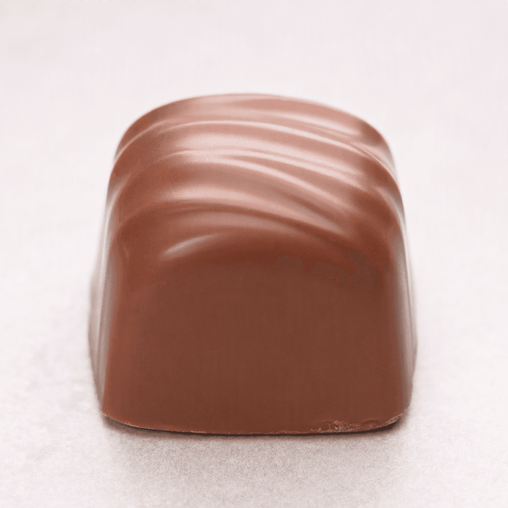 A small, bite-sized milk-chocolate praline with a smooth, softly rounded shape and a gently rippled surface.