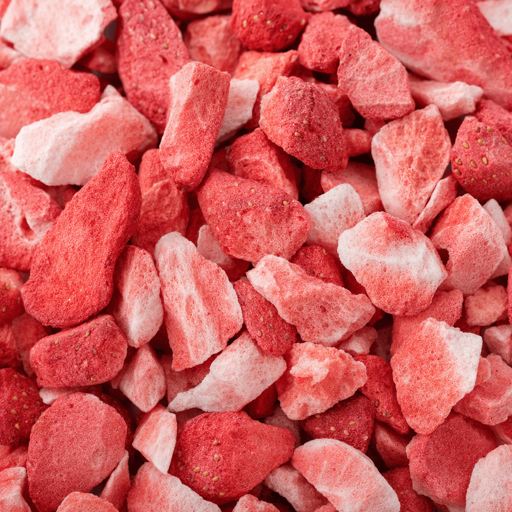 Irregular strawberry pieces, ranging from deep red to pale pink, with a dry, lightweight, porous surface and tiny visible seeds.