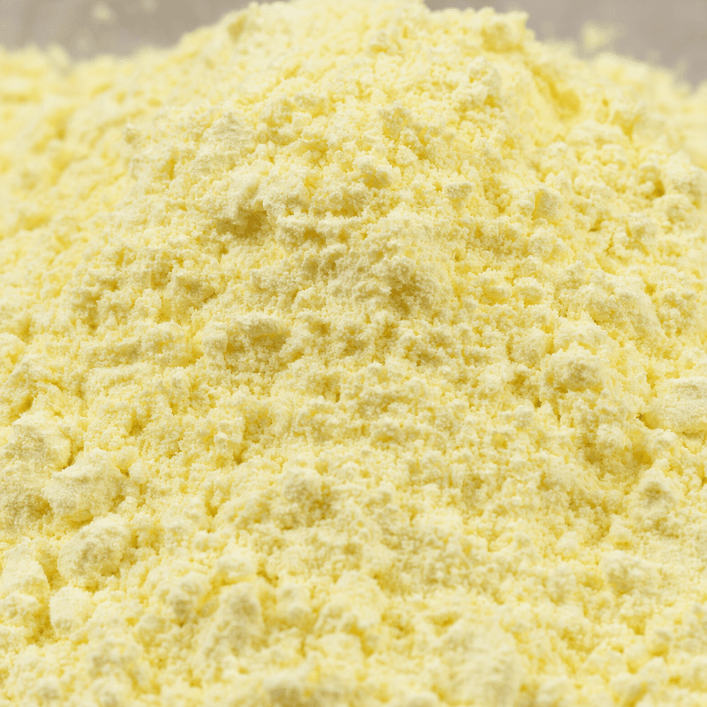 A fine, loose powder in a pale cream-yellow colour, with a soft, slightly grainy texture.