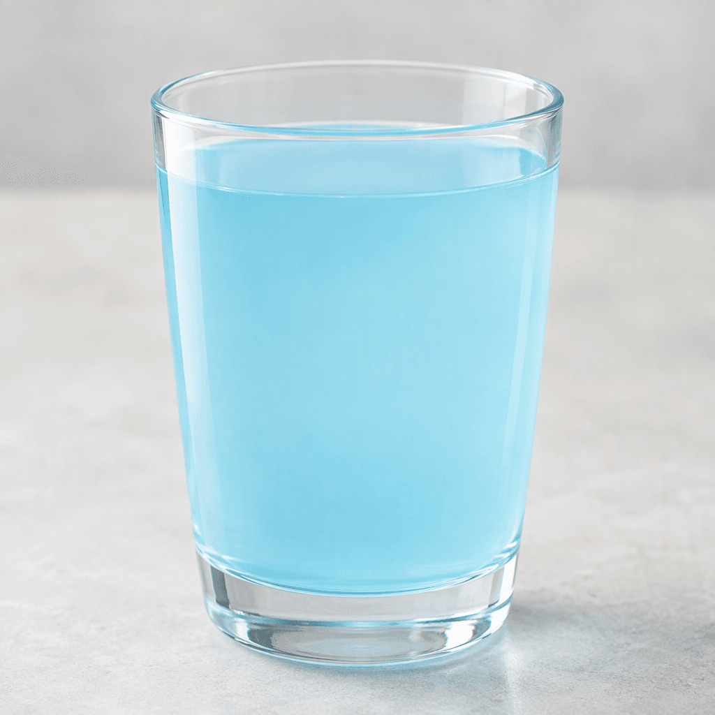 A translucent pale-blue liquid is served in a clear glass, with a smooth surface and no visible pieces or garnish.