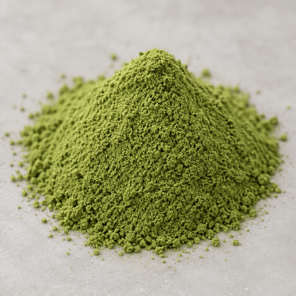 A small mound of finely ground, matte green powder with a uniform, slightly grainy texture.