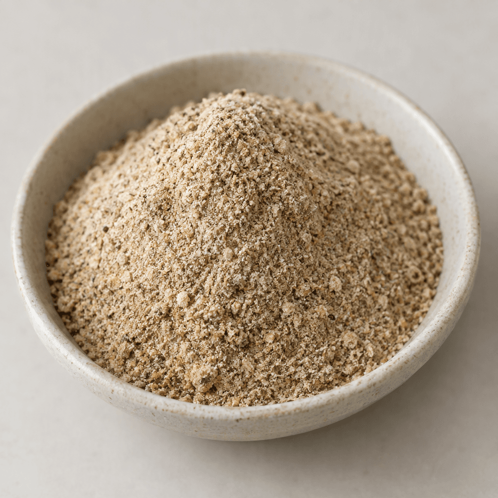 A loose, finely ground mushroom latte mix in a soft beige-brown shade, with a slightly grainy, even texture.