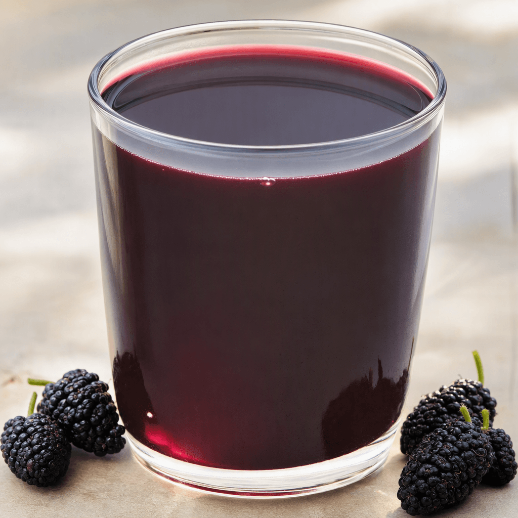 Deep, dark purple-black mulberry juice with a smooth, slightly translucent surface and reddish highlights fills a clear glass.