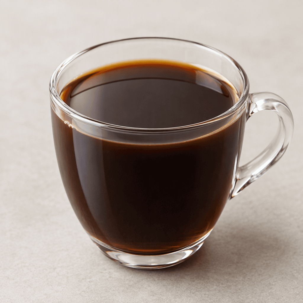 A clear, deep-brown cup of coffee with a smooth, glossy surface and no visible milk or garnish.