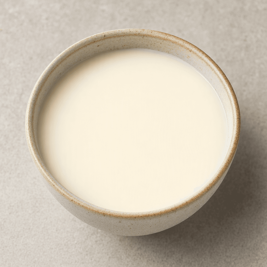 A small serving of opaque, pale ivory-white liquid with a smooth, uniform appearance.