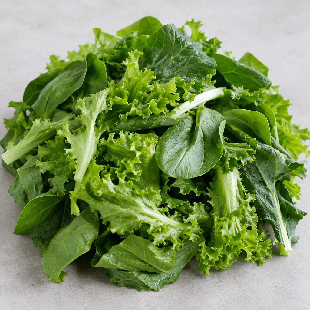 A loose pile of fresh leafy green vegetables with broad and frilly leaves in shades of bright to deep green, some pale stems and visible veins, arranged naturally on a plain surface.